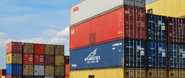 shipping containers stacked on tarmac