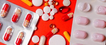 image of blister packs, pills, capsules on a bright pink background