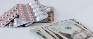 blister packs of pills and money