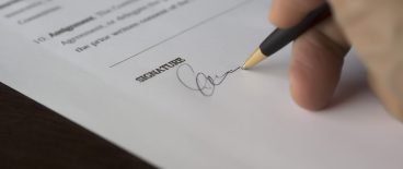 image of hand signing paper