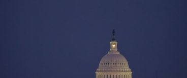 nighttime image of capitol dome with full moon