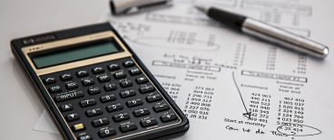 calculator, pen and financial estimates