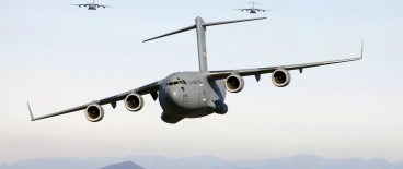 military airplanes in formation flying over mountains