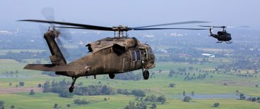 helicoptors flying over green fields