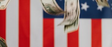 image of money falling in front of american flag