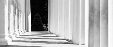 image of walkway at the U.S. Supreme Court between limestone columns with shadow