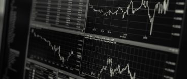 black nd white image of stock market performance charts on computer screen