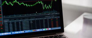 image of laptop screen showing stock performance graphs