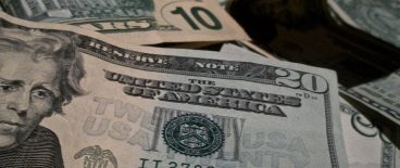 Image of tens, 20s and 5 dollar bills in a pile