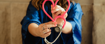 a woman holding a stethoscope