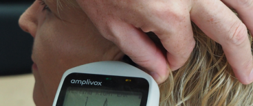 doctor checking patients ears with a tympanometer