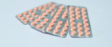 orange pills on a blue background