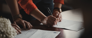people signing documents