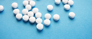 white tablets scattered on a blue background