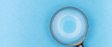 magnifying glass against light blue background