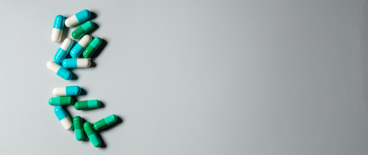 white and blue and green pills on a white background
