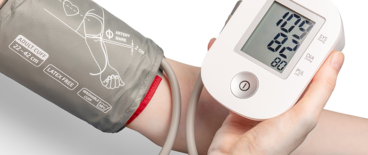 person checking their heart pressure on a heart pressure machine