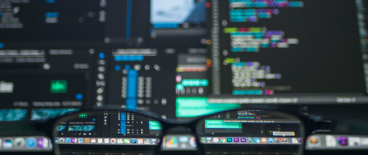 glasses with computer monitors in the background