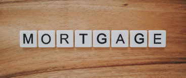 tile letters spelling mortgage on a wooden background