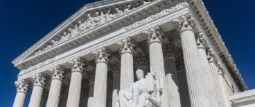 photo of supreme court building against blue sky background