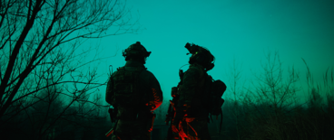 military personnel searching for something in the dark wood