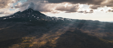 a landscape of a mountain in the clouds