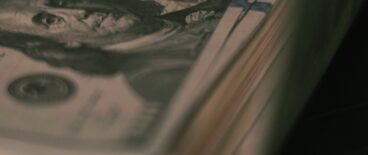 stalk of hundred dollar bills