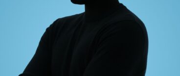 a silhouette of a person in the dark on a blue background