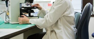 a scientist looking at something on a microscope