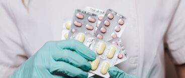 a nurse holding a bunch of medicine
