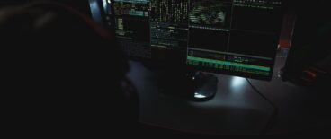 a person using the computer in a dark room