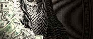 money with a hundred dollar bill blown up in the background