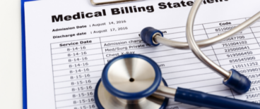 stethoscope on top of a medical billing statement