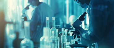 scientists in a lab using microscopes