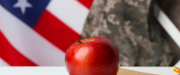 an apple on a notebook with the American flag in the background