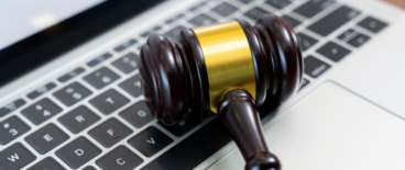 judge's gavel on top of a laptop